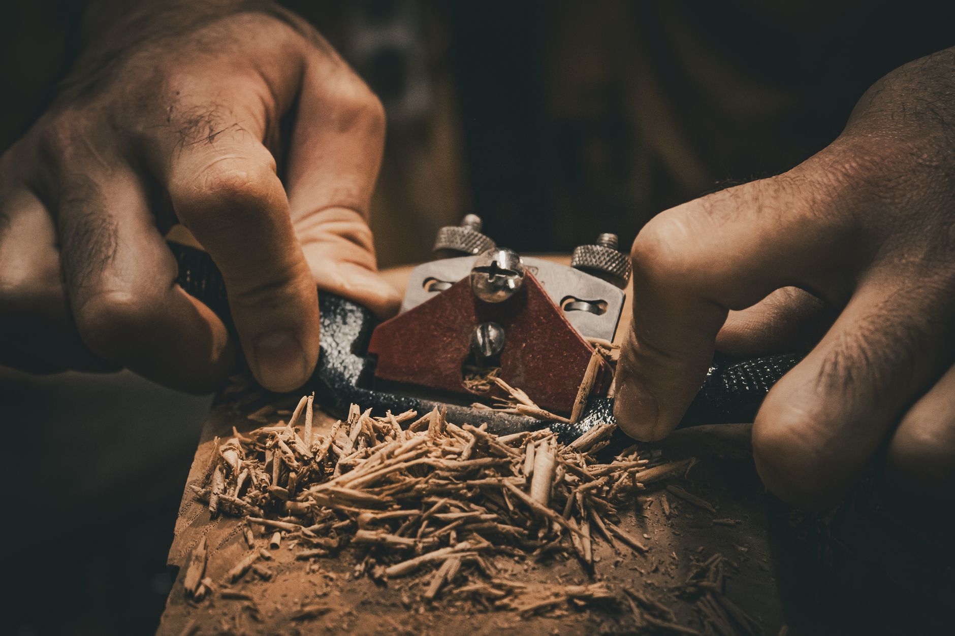 close up of woodworking with hand plane tool