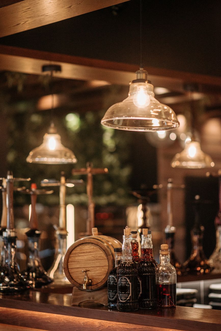 bottles of alcoholic drinks near a barrel